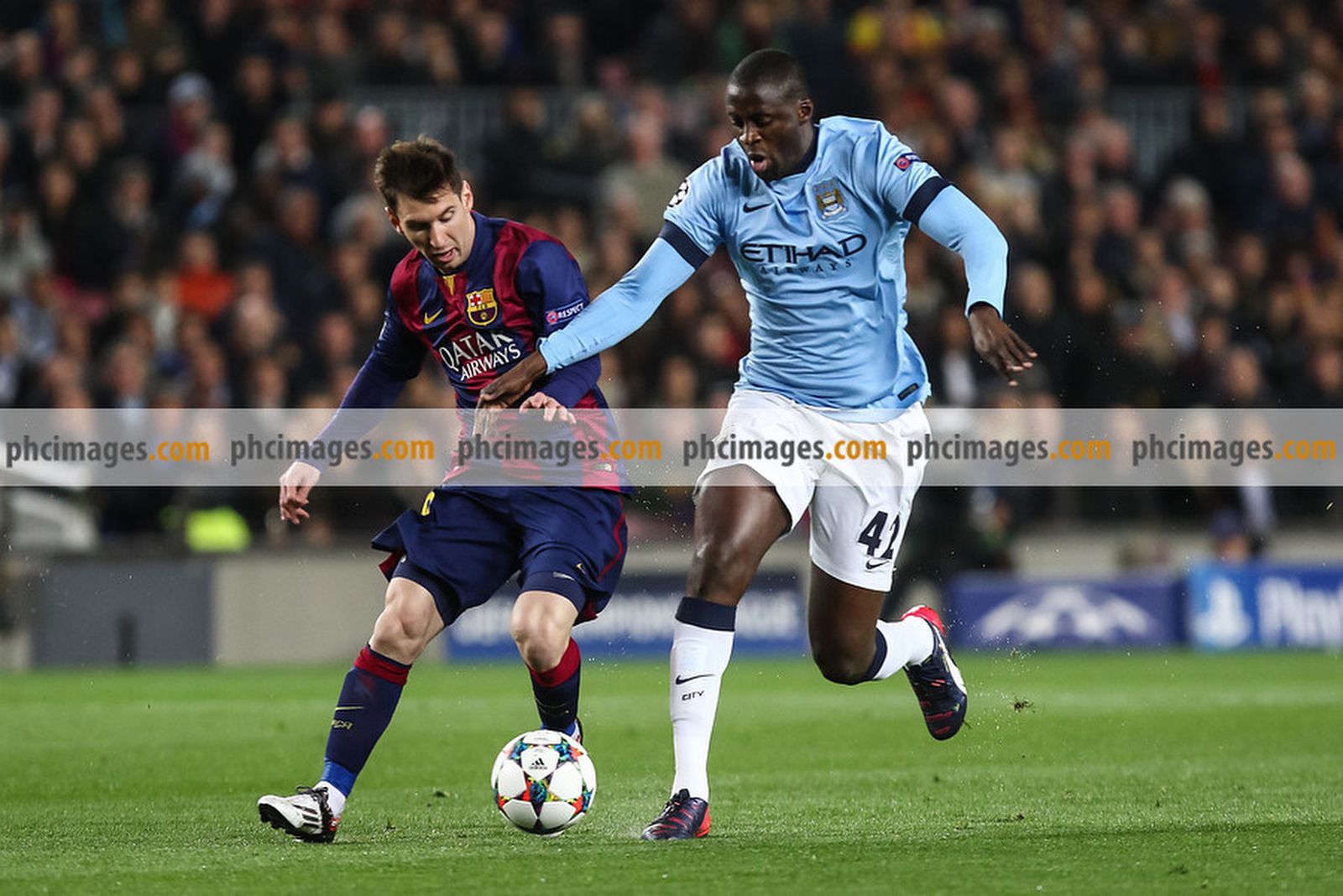 Messi and Toure compete for the ball
