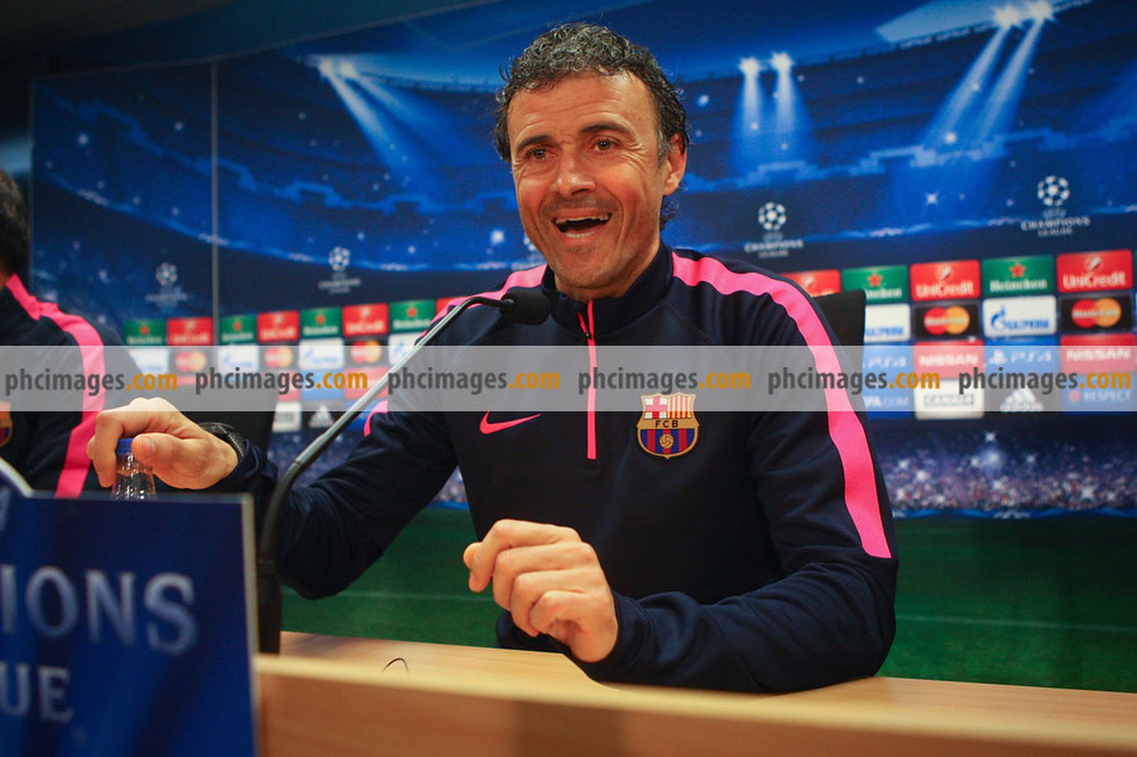 FC Barcelona manager Luis Enrique laughs as he sits down for the press conference