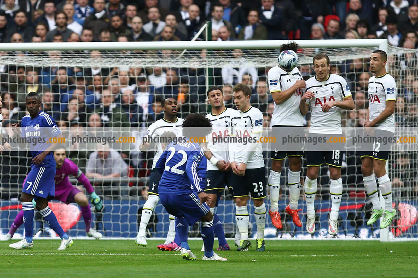 Willian curls a free kick over the Spurs wall