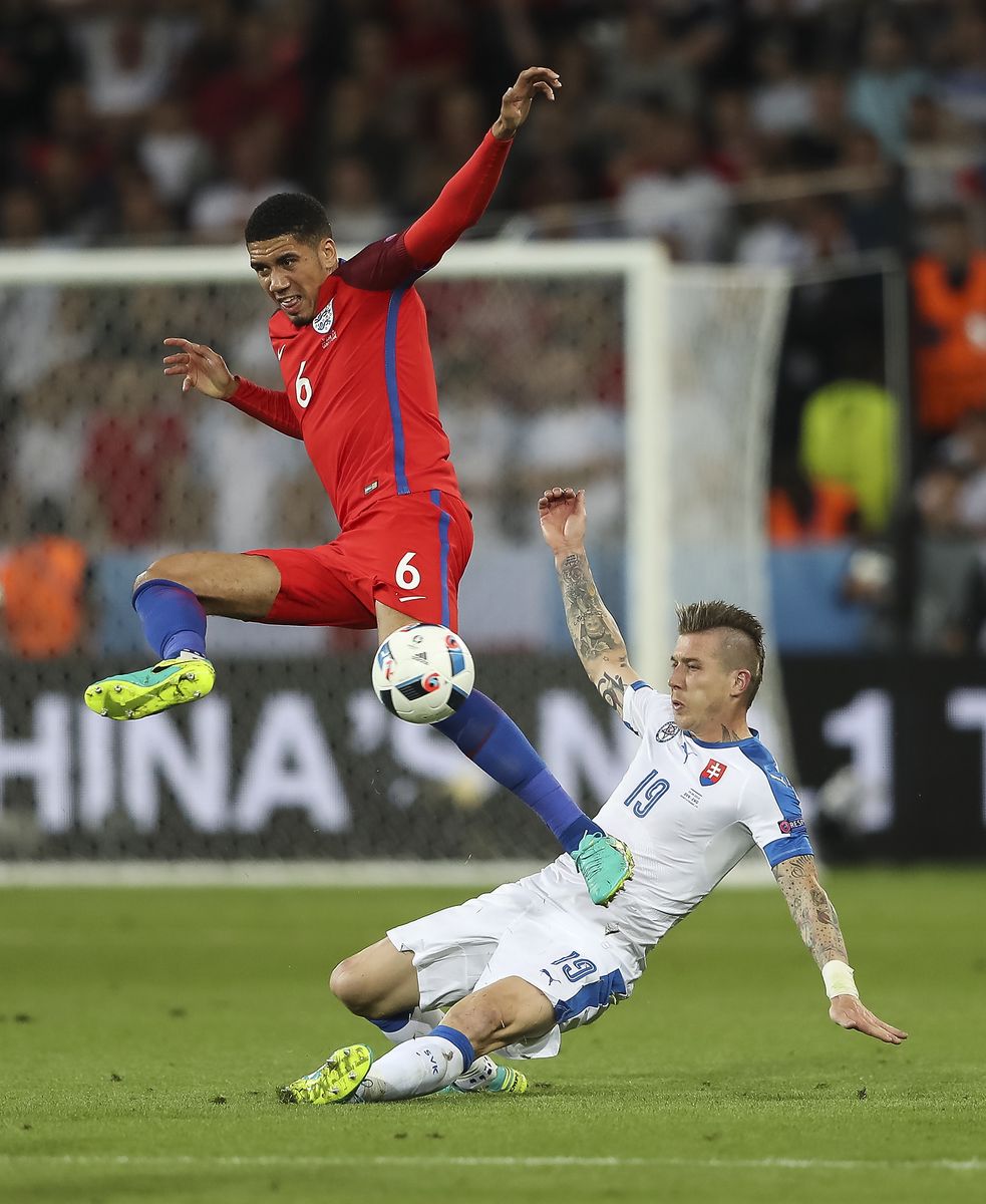 Chris Smalling and Juraj Kucka compete for the ball