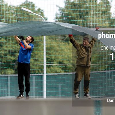 Workers install a large fence at Stadium Spartak Zelenogorsk