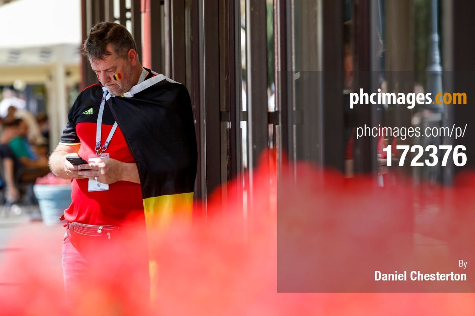 A Belgium fan waits near the ground before the match