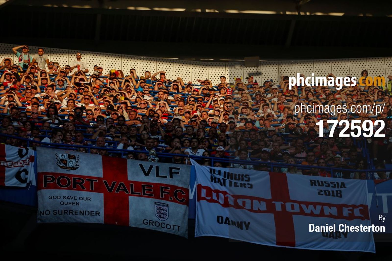 Fans watch on in the evening sun