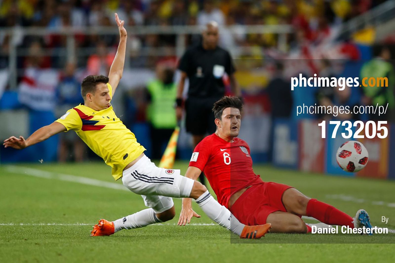 Harry Maguire plays a ball down the line under pressure from Santiago Arias