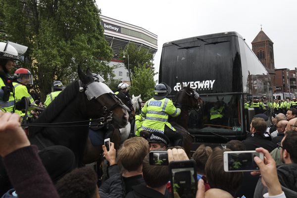 The Manchester United team coach tries to get through traffic on Green Street
