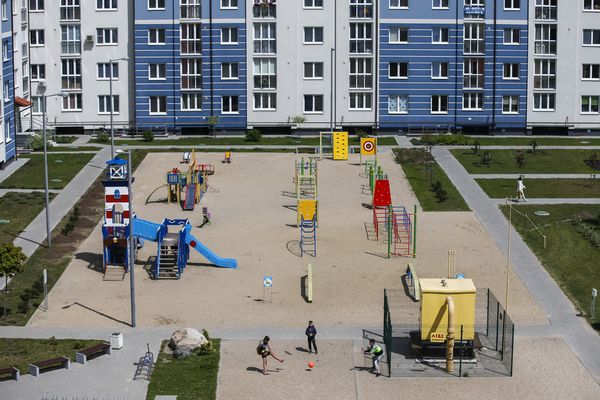 Young boys play football in a park in front of a block of apartments in Kaliningrad, Russia