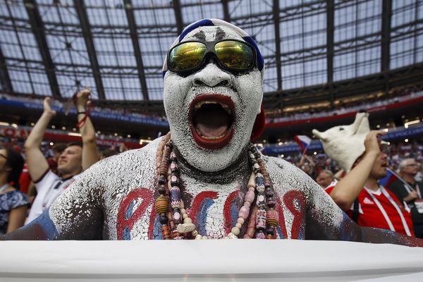 A Russia fan celebrates after beating Spain