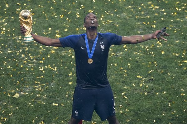 Paul Pogba celebrates with the World Cup trophy