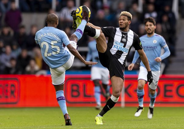 Fernandinho and Joelinton compete for the ball
