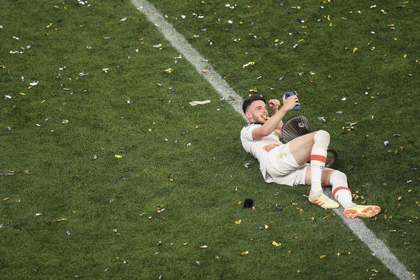 Declan Rice takes a selfie on the pitch with the trophy long after the final whistle